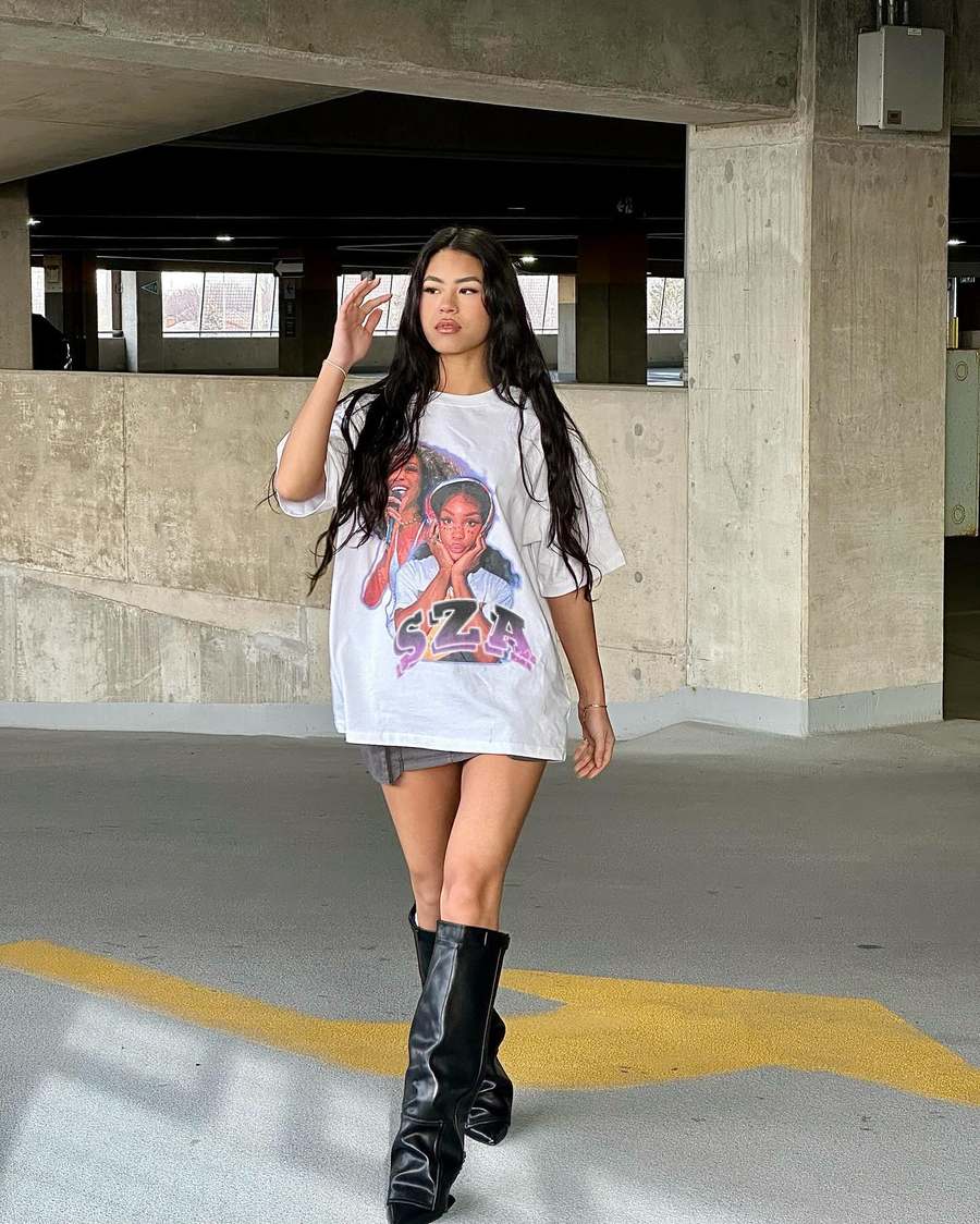 Customer in an oversized graphic tee and boots