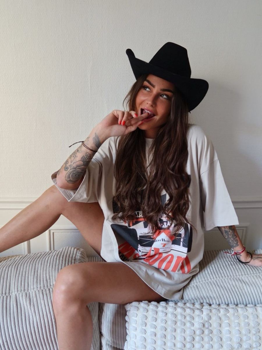 Customer in an oversized cream graphic tee