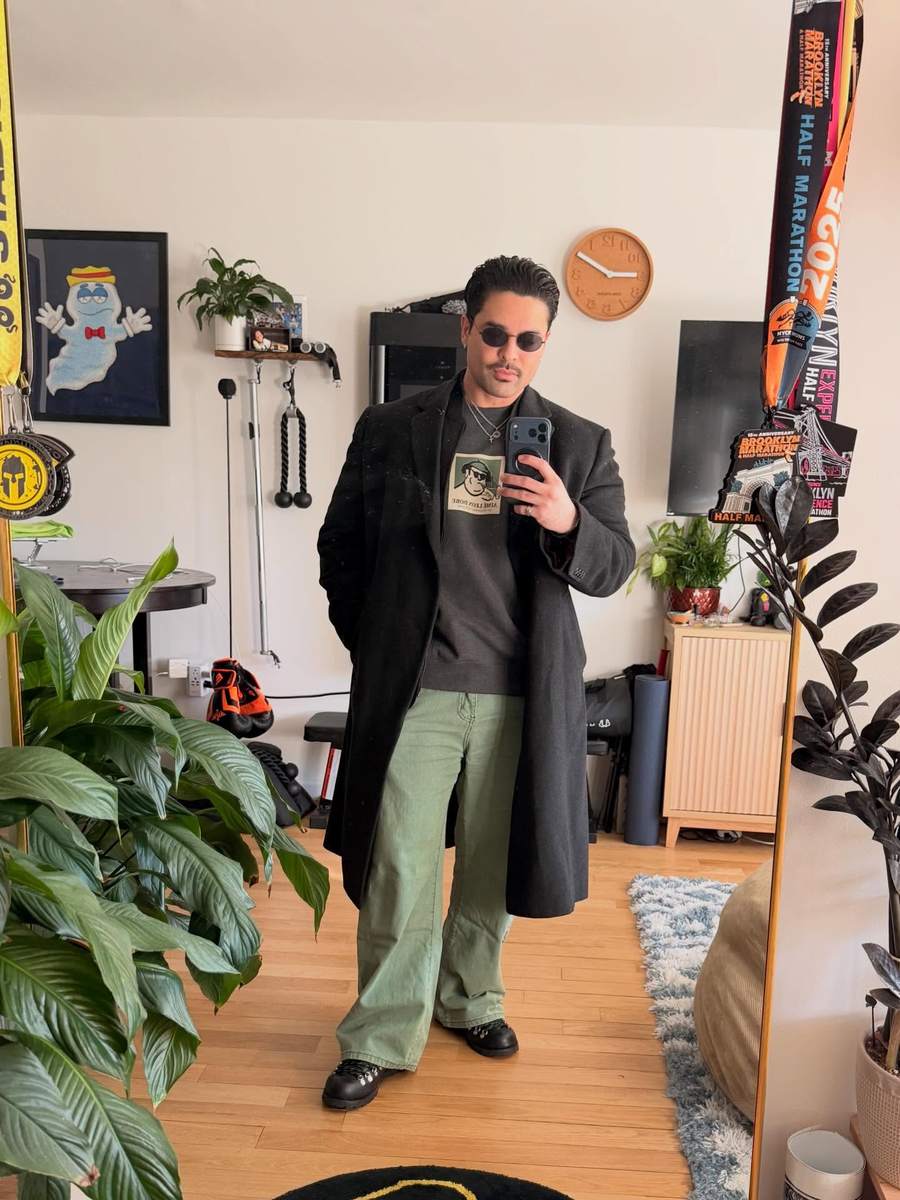 Customer in a graphic sweatshirt with a long coat