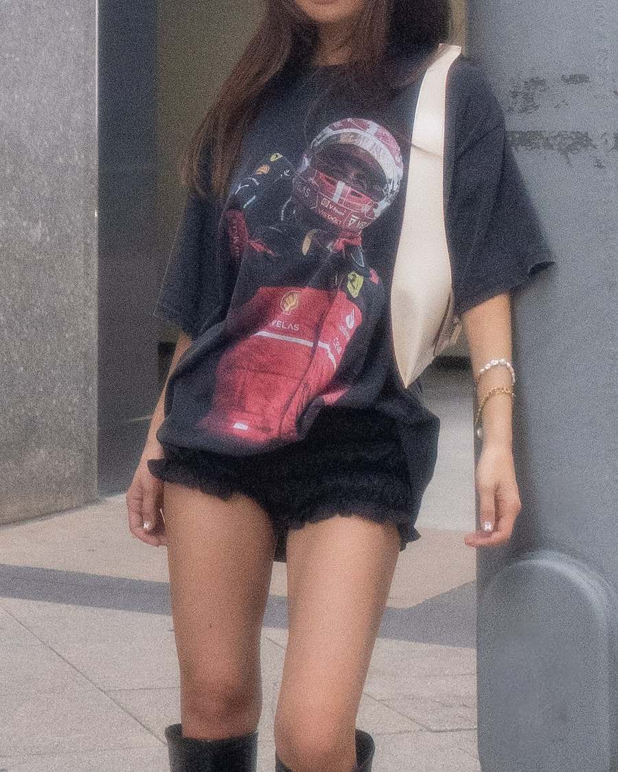 Customer in a washed black oversized racing tee
